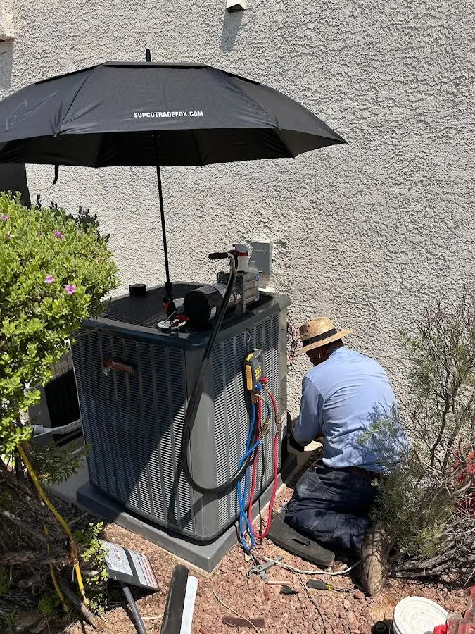 HVAC technician performing outdoor AC maintenance in Templeton